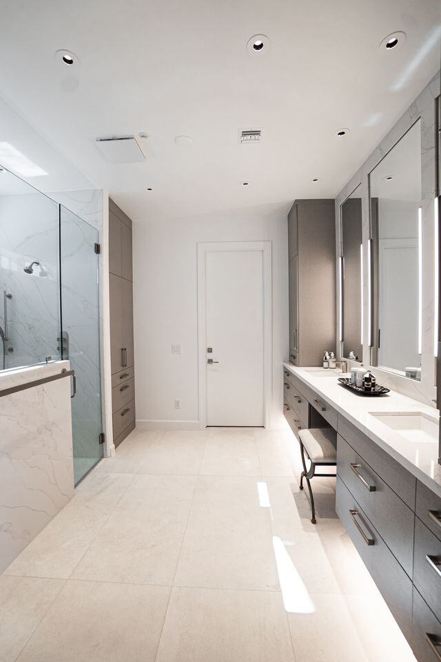 Contemporary bathroom remodel featuring a floating vanity and glass-enclosed shower, completed by MGD Builders in Phoenix, AZ