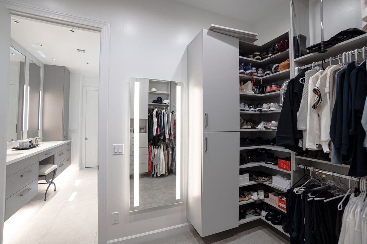 Modern vanity with custom drawers and a backlit mirror, part of a Phoenix bathroom remodel by MGD Builders