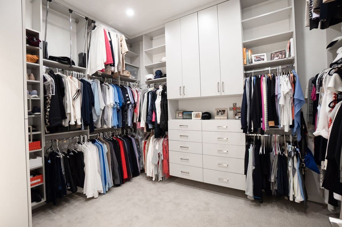 Spacious walk-in closet with custom shelving and ample storage, designed by MGD Builders in Phoenix, AZ