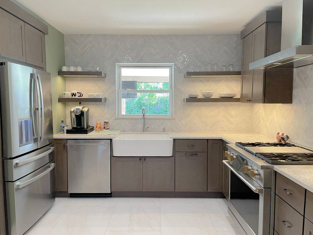 Modern kitchen remodel by MGD Builders in Phoenix, AZ, featuring stainless steel appliances and a farmhouse sink