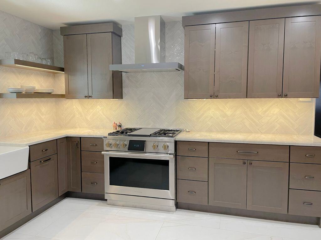 Modern kitchen with dark cabinetry and stainless steel stove, remodeled by MGD Builders in Phoenix, AZ