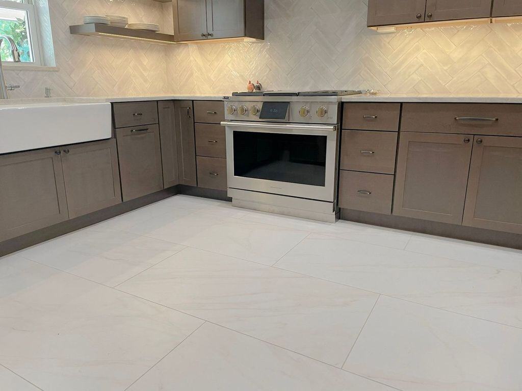 Spacious kitchen with grey cabinetry and new tile floors, remodeled by MGD Builders in Phoenix, AZ