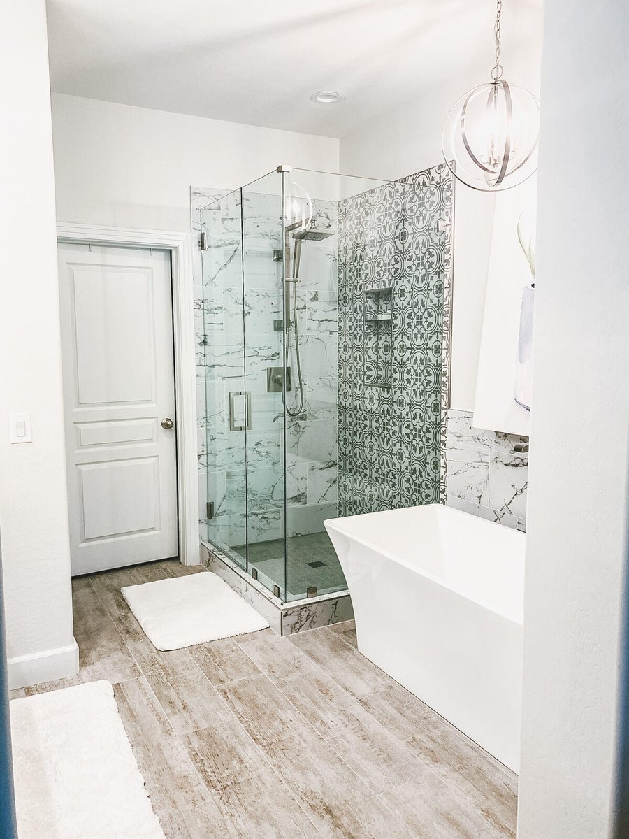 Bathroom remodel in Phoenix, AZ featuring a freestanding bathtub and glass shower by MGD Builders