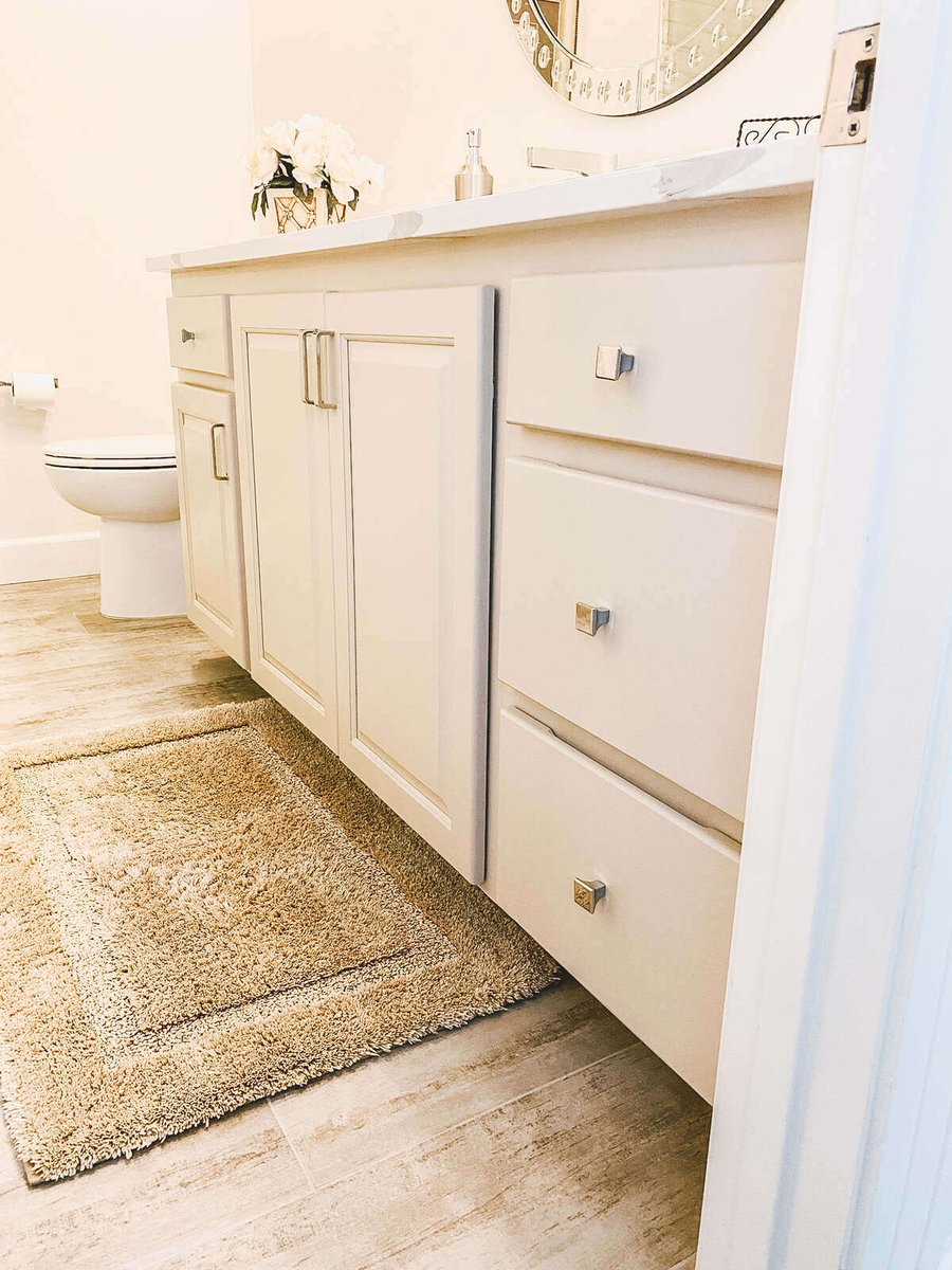 Bathroom vanity with white cabinetry and mirror, remodeled by MGD Builders in Phoenix, AZ