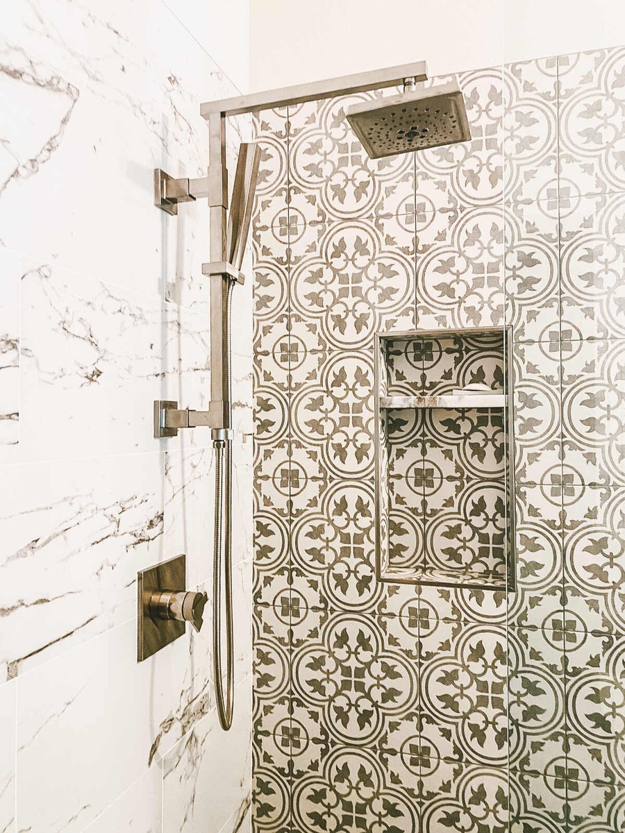 Decorative tiled shower with rainfall showerhead in Phoenix, AZ bathroom remodel by MGD Builders