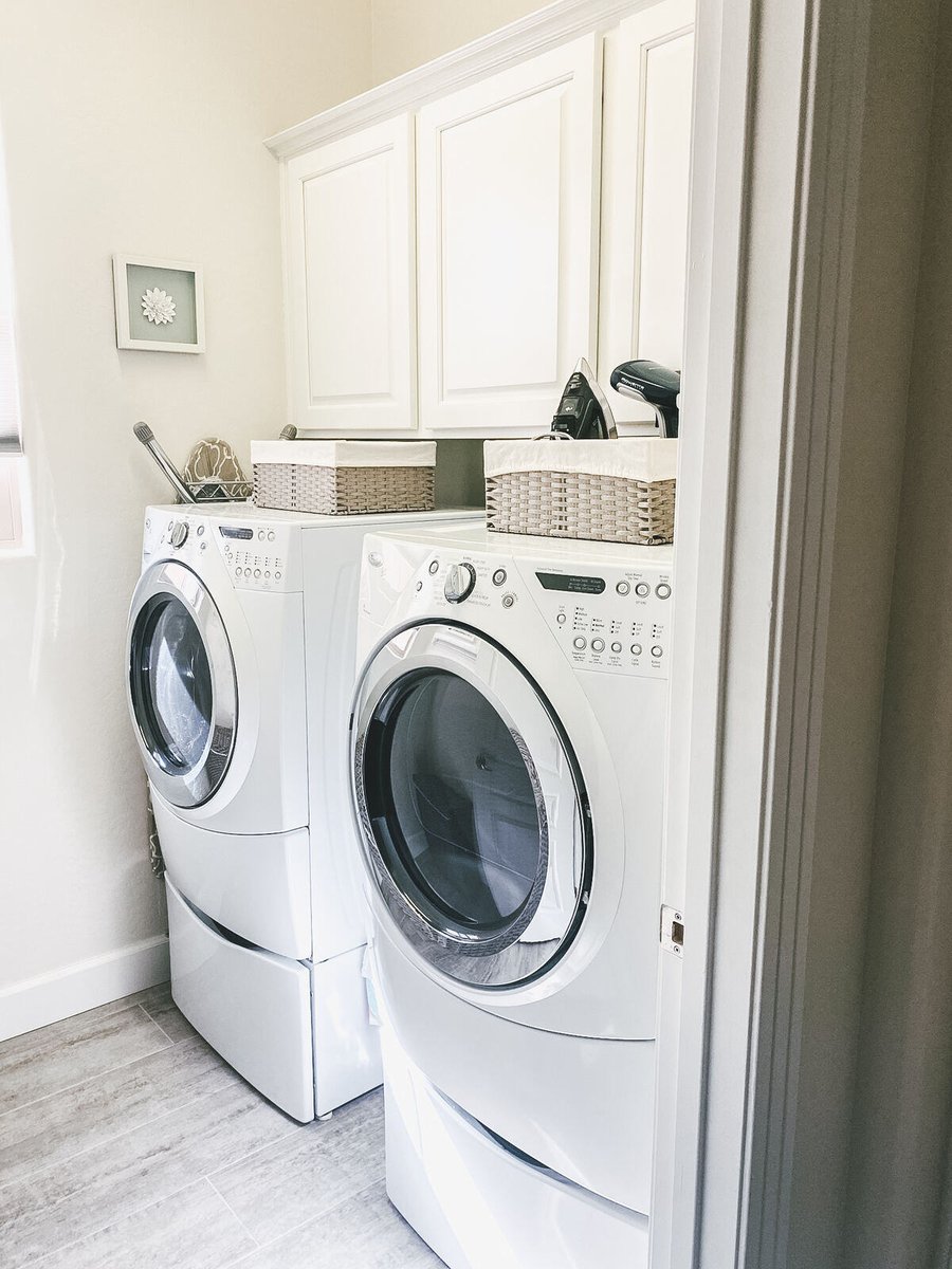 Laundry room with modern washer and dryer in Phoenix, AZ home remodeled by MGD Builders