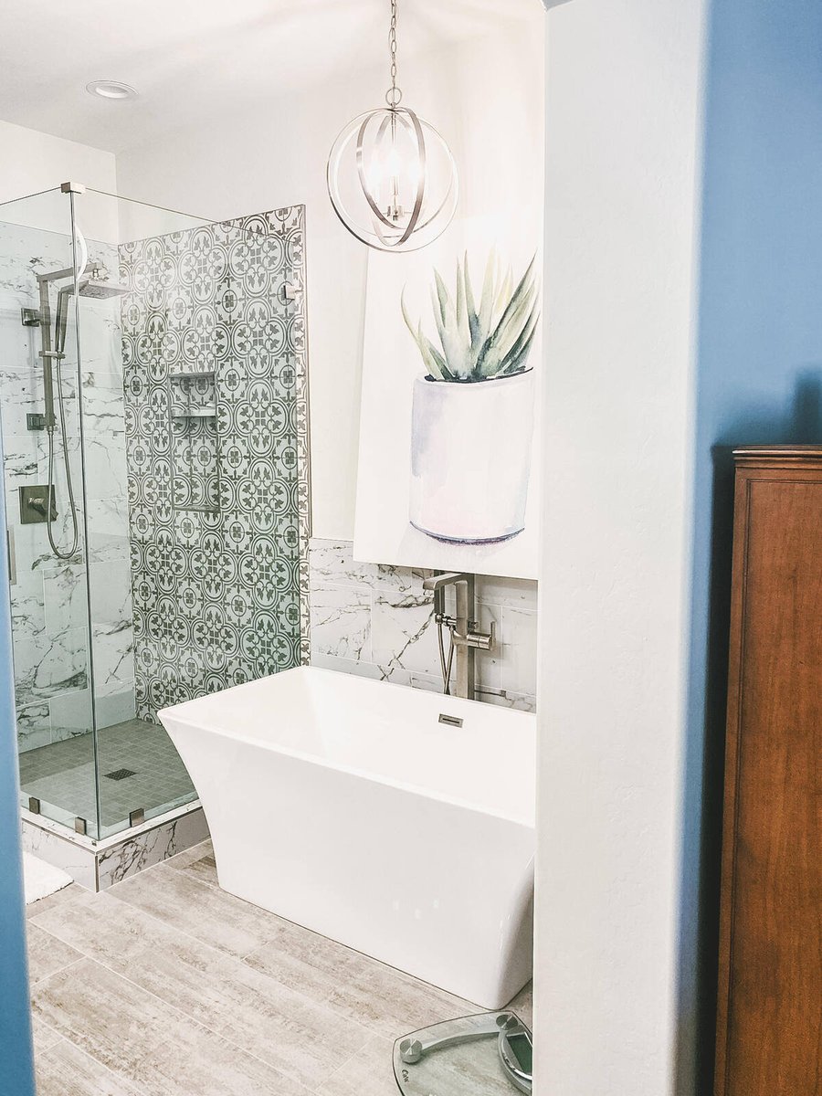 Master bathroom entry with modern bathtub and glass shower in a Phoenix, AZ remodel by MGD Builders