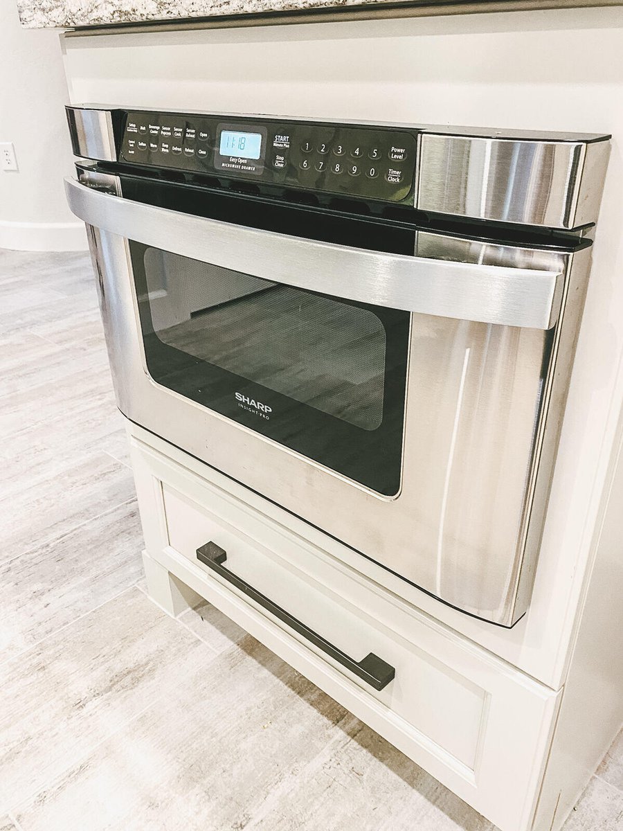 Microwave and granite countertop in a modern kitchen remodel by MGD Builders in Phoenix, AZ