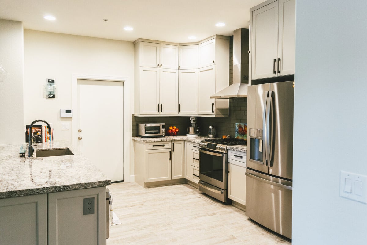 Modern kitchen with island and stainless steel appliances, remodeled by MGD Builders in Phoenix, AZ