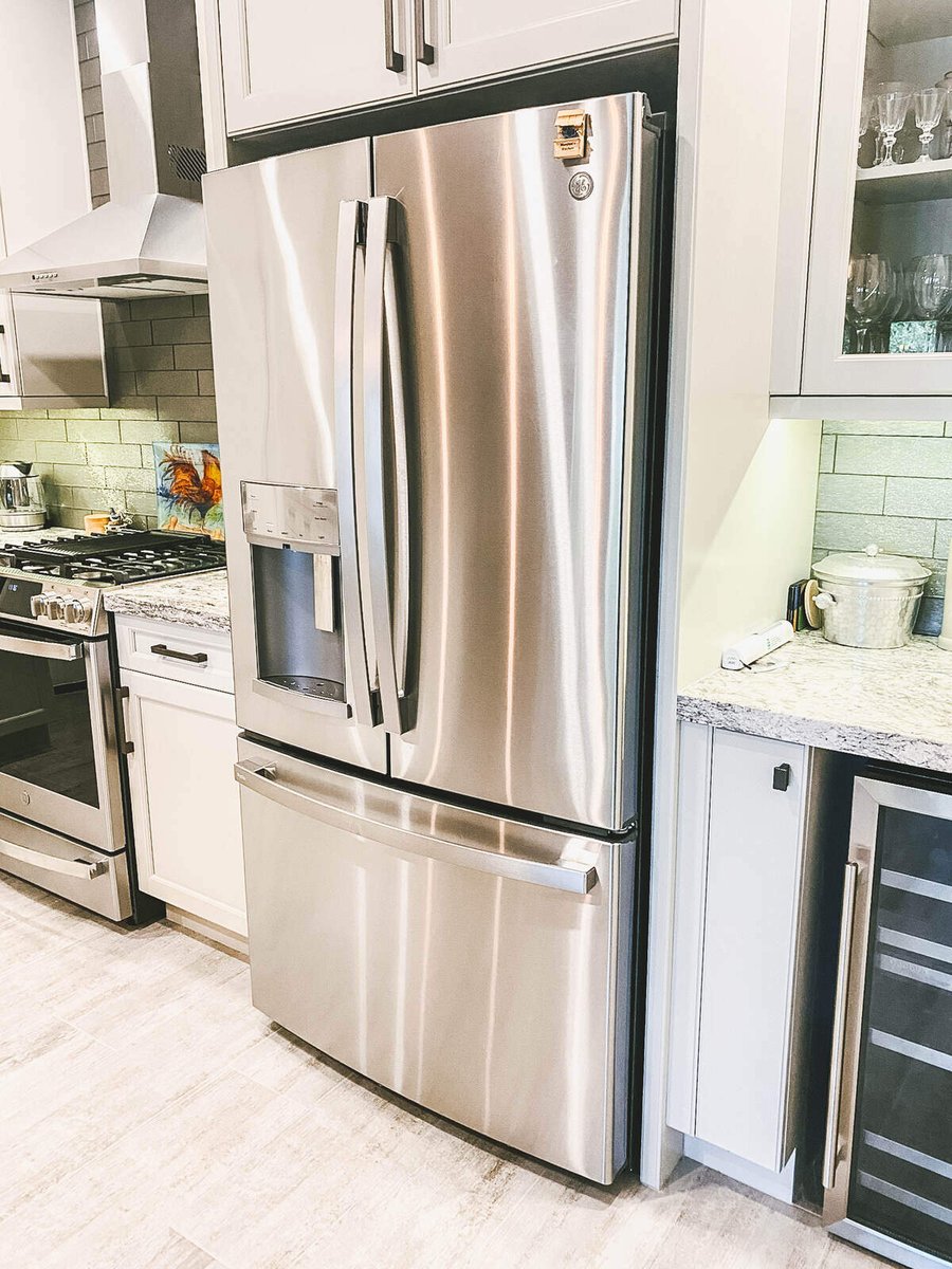 Stainless steel refrigerator and modern cabinetry in a Phoenix, AZ kitchen remodel by MGD Builders