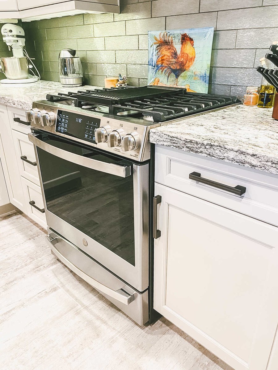 Stainless steel stove and granite countertop in a remodeled kitchen by MGD Builders in Phoenix, AZ