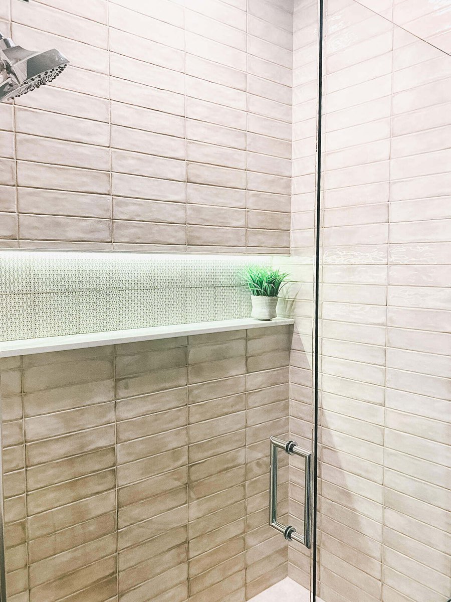 Tiled shower with built-in shelf and chrome fixtures, remodeled by MGD Builders in Phoenix, AZ