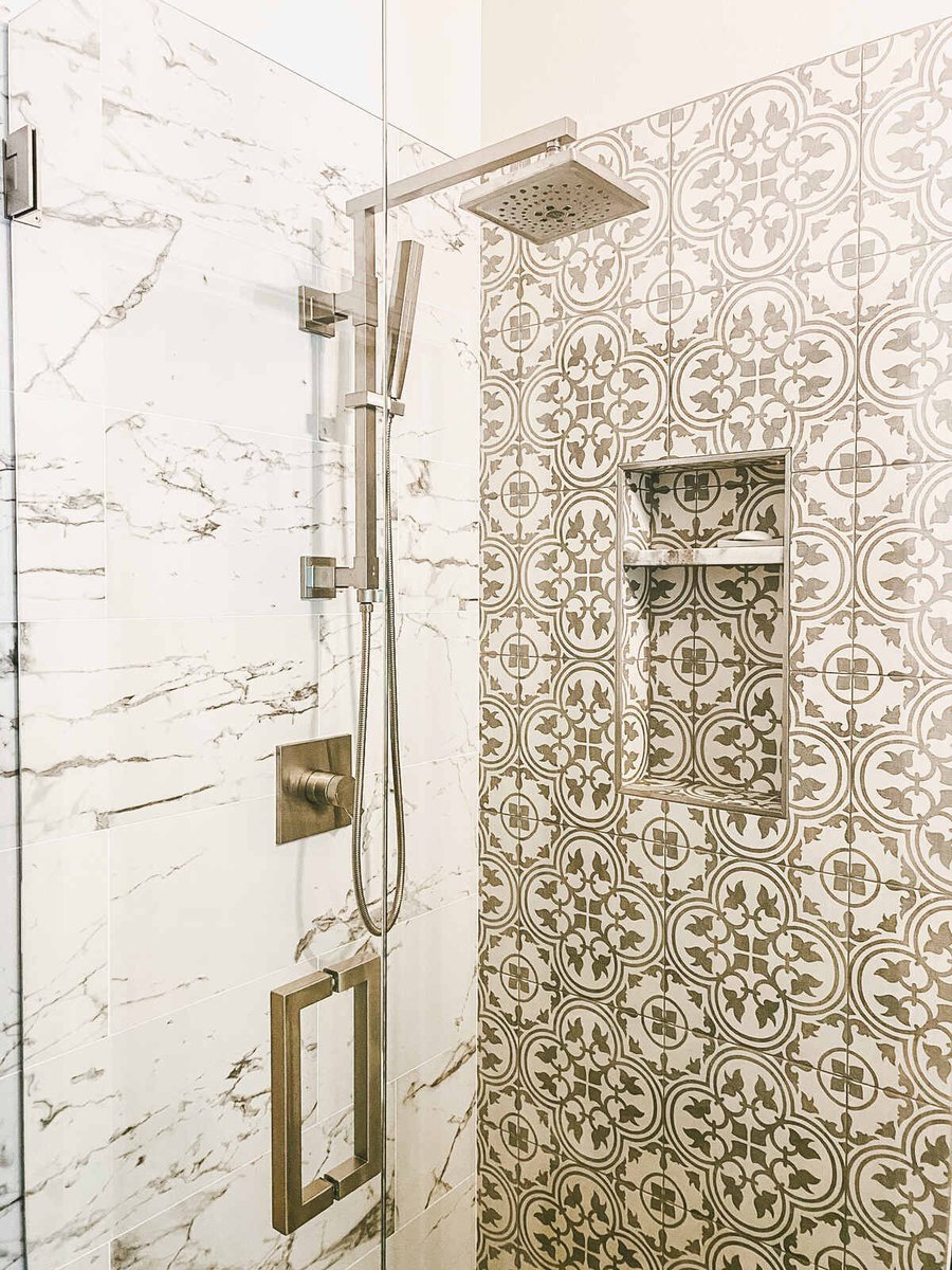 Tiled shower with rainfall showerhead and glass door in Phoenix, AZ bathroom remodel by MGD Builders