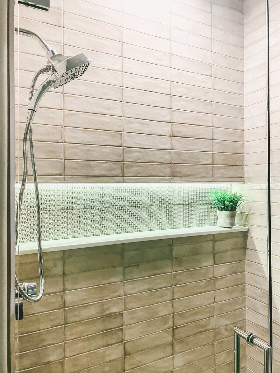 Tiled walk-in shower with chrome fixtures, part of a Phoenix, AZ remodel by MGD Builders