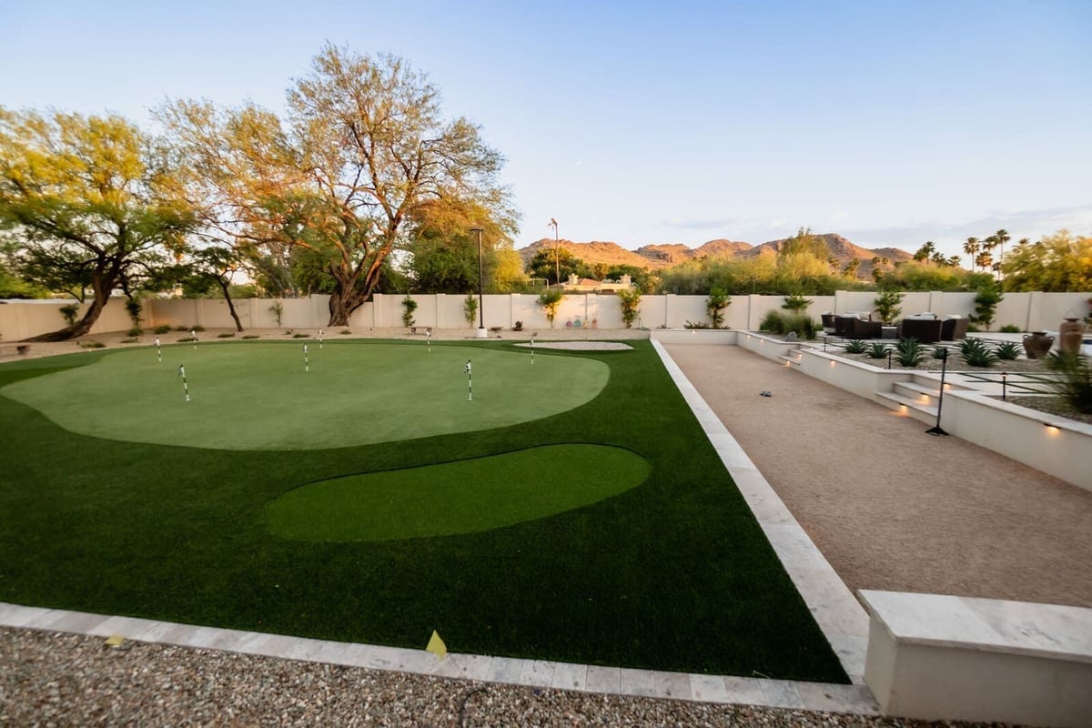 Custom backyard with putting green and desert mountains, part of a Phoenix, AZ renovation by MGD Builders 