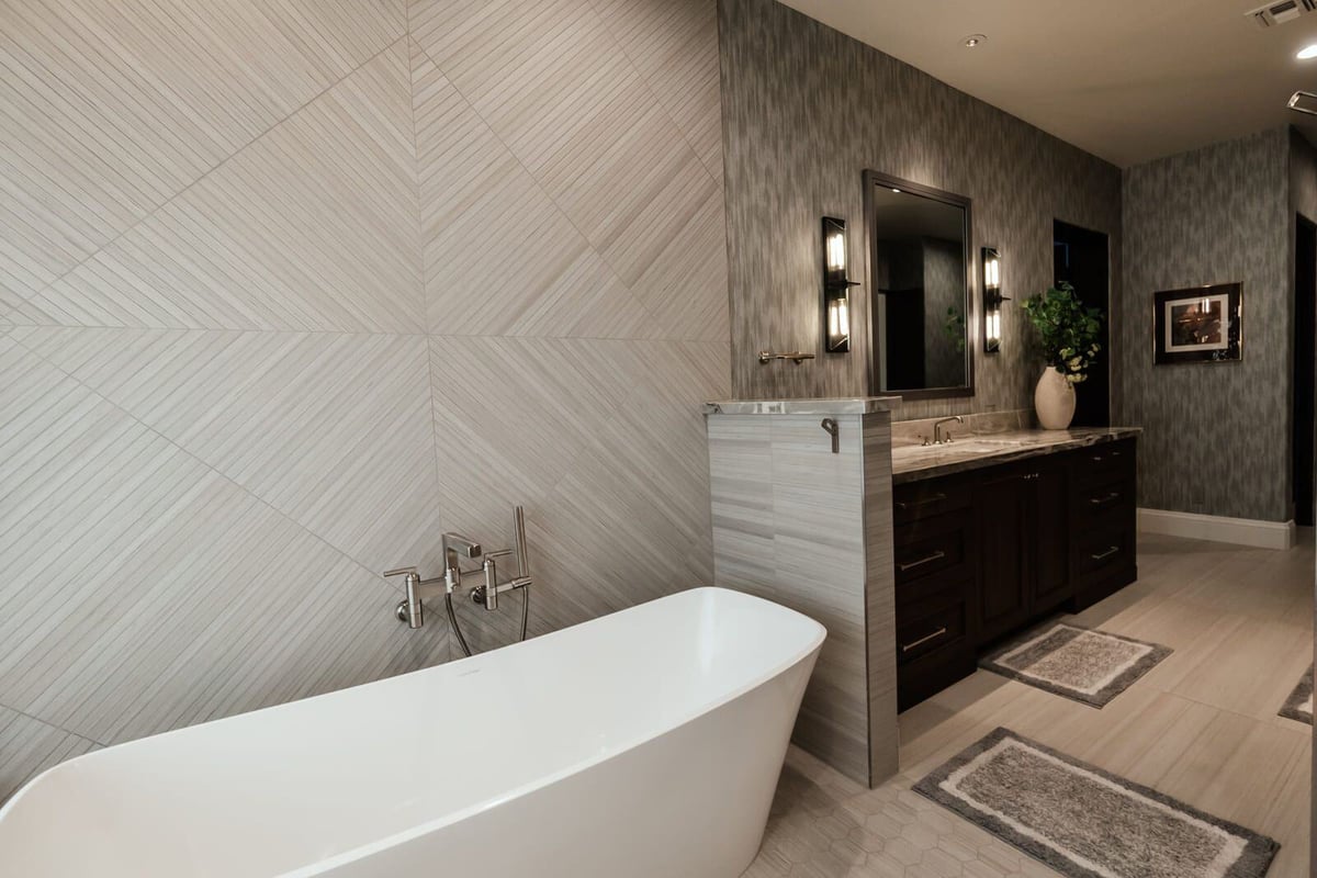 Custom bathroom with a freestanding tub and geometric wall tile, part of Phoenix renovation by MGD Builders 