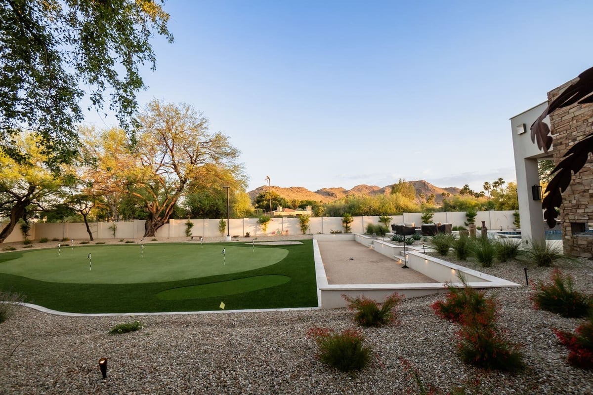 Custom-designed putting green in a modern Phoenix backyard, completed by MGD Builders as part of a renovation 