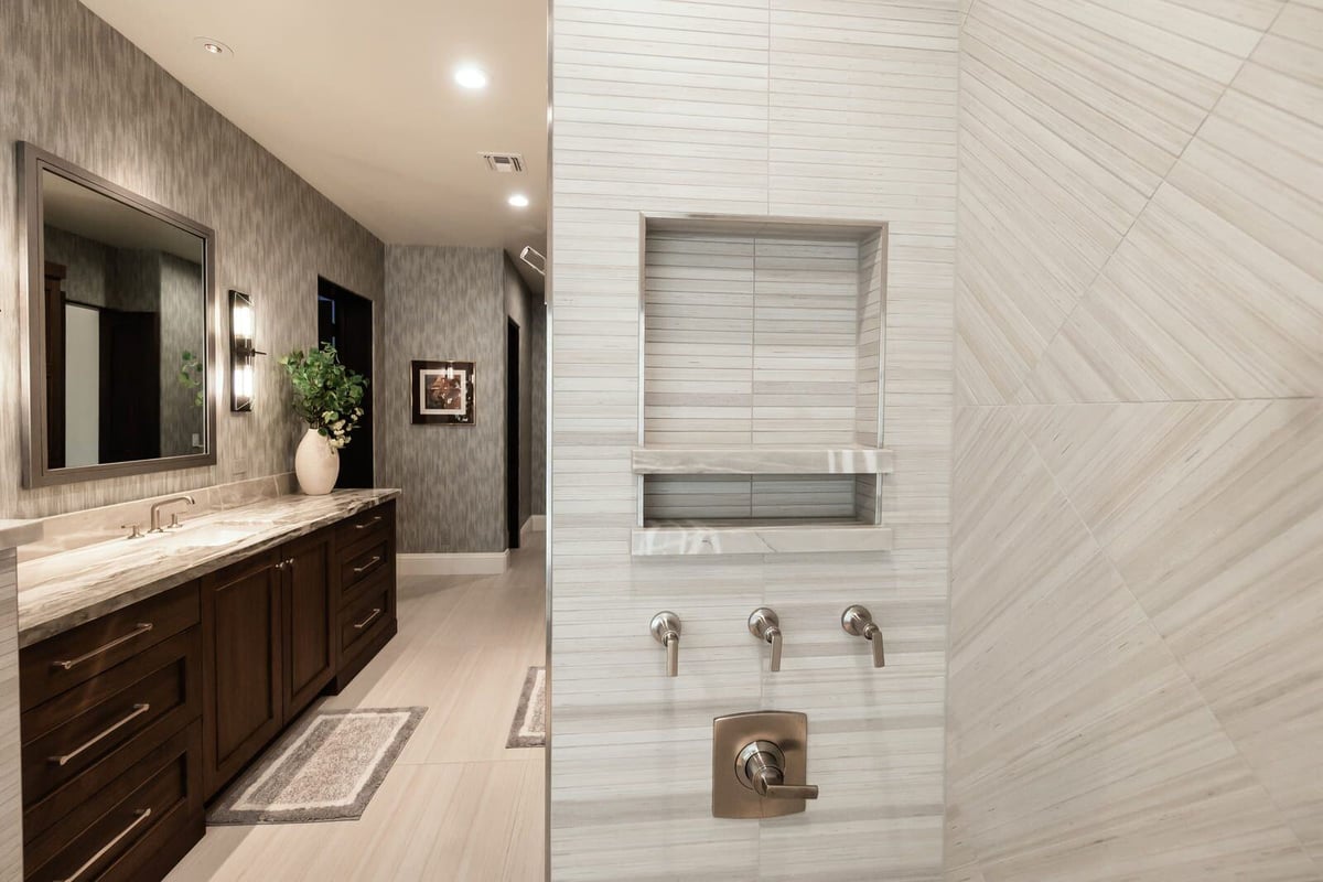 Elegant Phoenix bathroom renovation with a freestanding tub and built-in shower by MGD Builders 