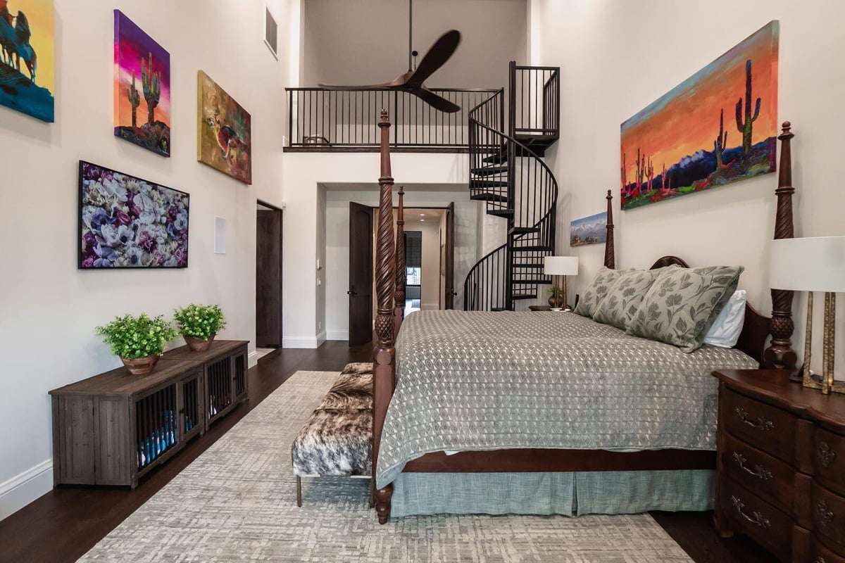 Elegant bedroom with spiral staircase and custom bed frame in Phoenix home remodel by MGD Builders 