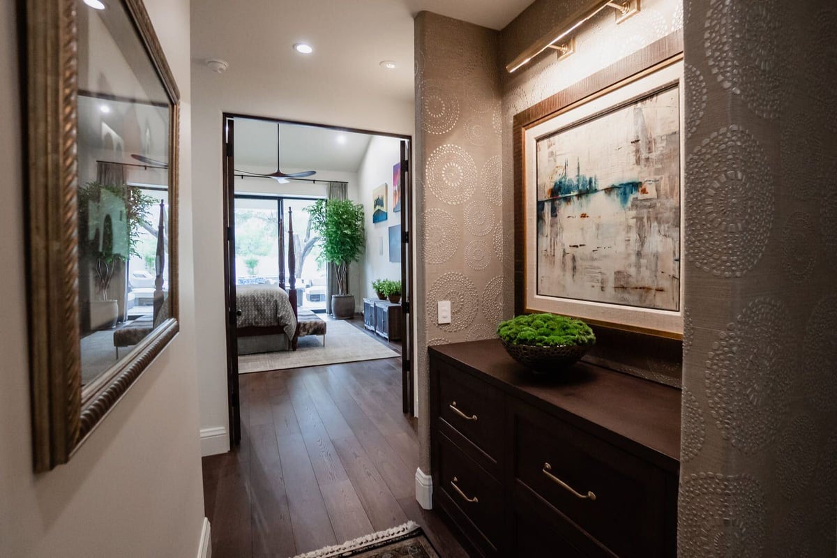 Hallway with framed artwork leading to bedroom in a Phoenix home remodeled by MGD Builders 