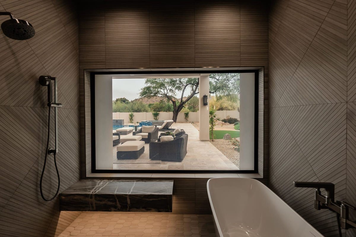 Luxurious bathroom featuring a soaking tub with a view, part of Phoenix renovation by MGD Builders 