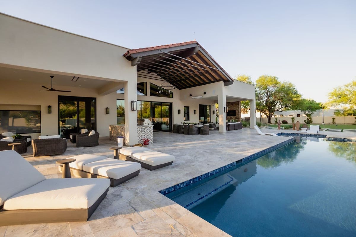 Luxury backyard pool with stone patio and covered lounge area, MGD Builders, Phoenix AZ 