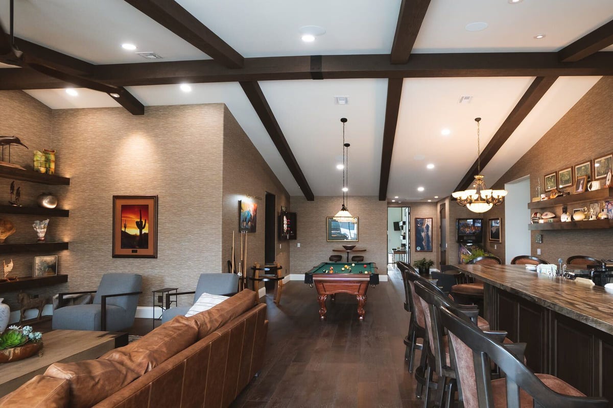 Modern entertainment room with pool table and seating area in a Phoenix home renovated by MGD Builders 