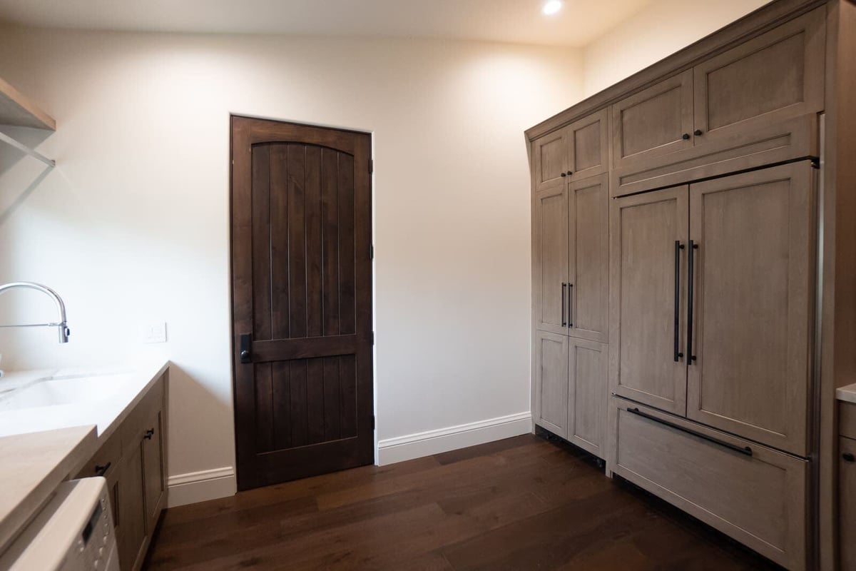 Modern kitchen remodel with wooden cabinets and a farmhouse-style door, MGD Builders, Phoenix AZ 