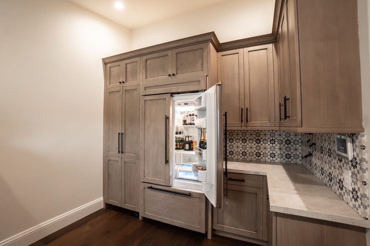 Open fridge inside a remodeled kitchen with custom wooden cabinets, MGD Builders, Phoenix AZ 