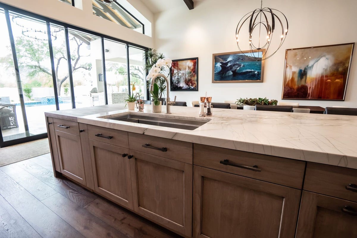 Open kitchen with large marble island and wood cabinetry, Mertel Whole Home Renovation, MGD Builders, Phoenix AZ 