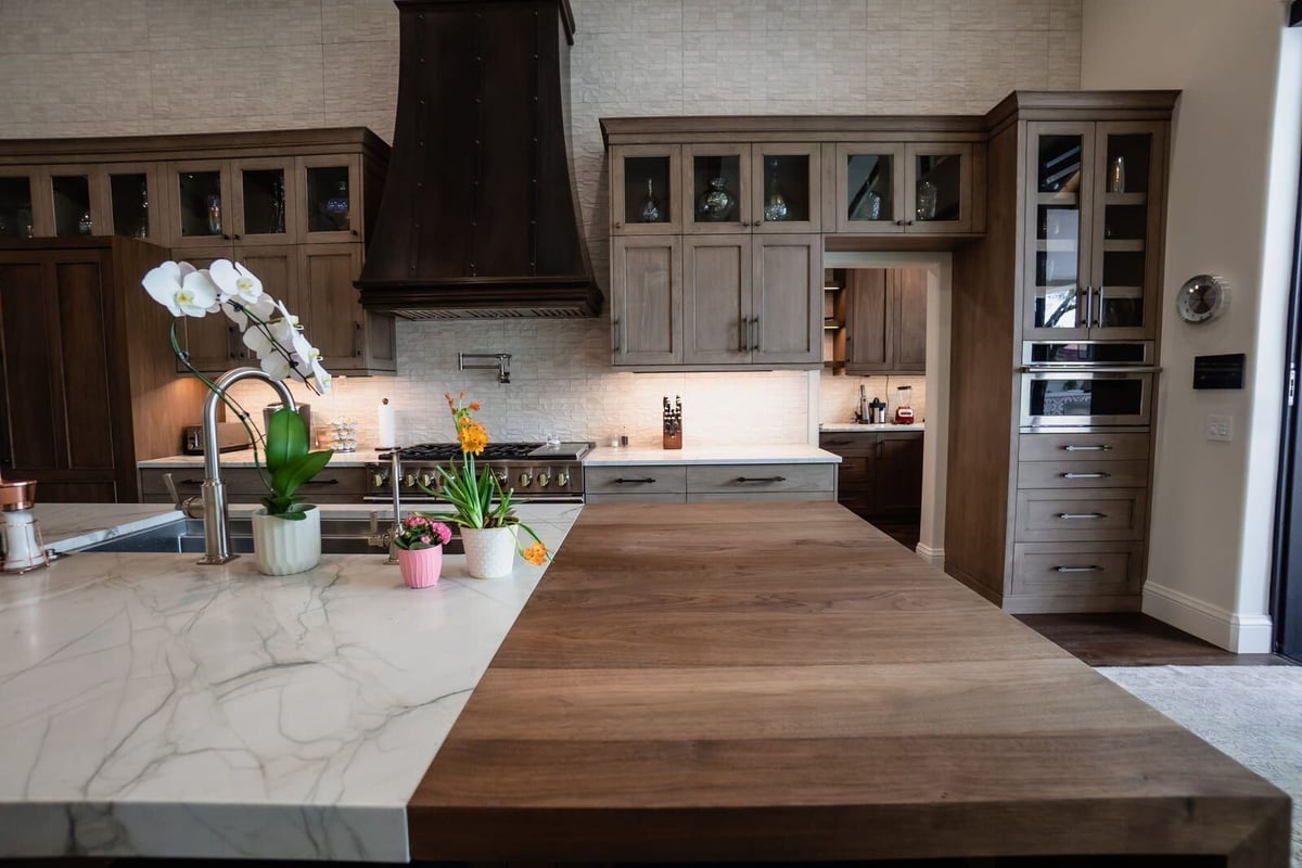 Open kitchen with wood cabinetry, marble island, and view into living room, Mertel Whole Home Renovation, MGD Builders, Phoenix AZ 