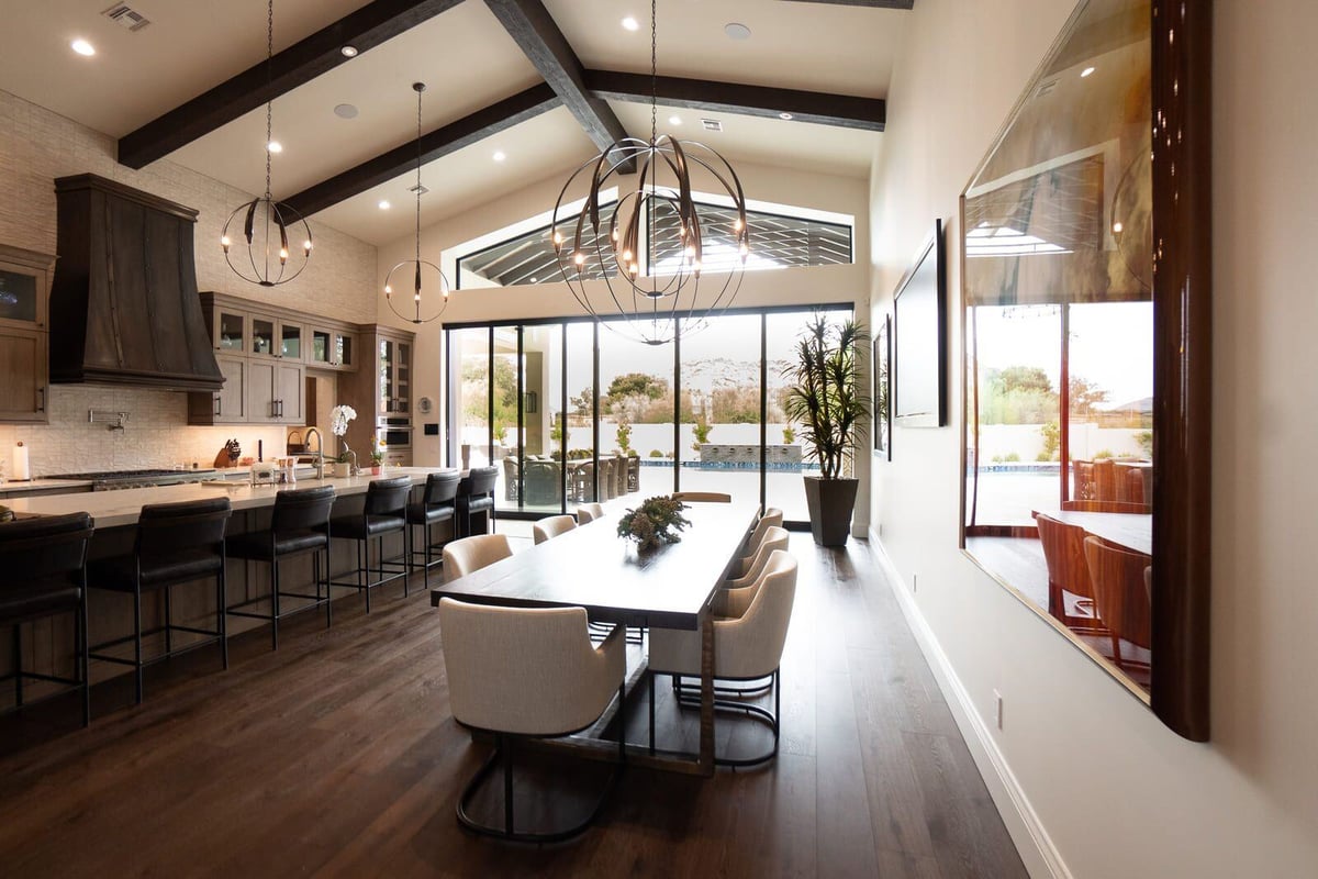 Open-concept kitchen and dining area with modern lighting in a Phoenix home renovation by MGD Builders 