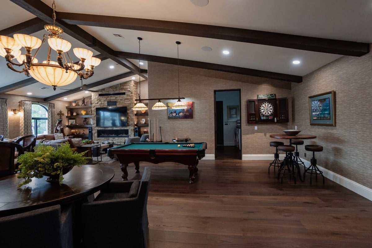 Spacious living room featuring pool table, fireplace, and wood-beamed ceiling, MGD Builders, Phoenix AZ 