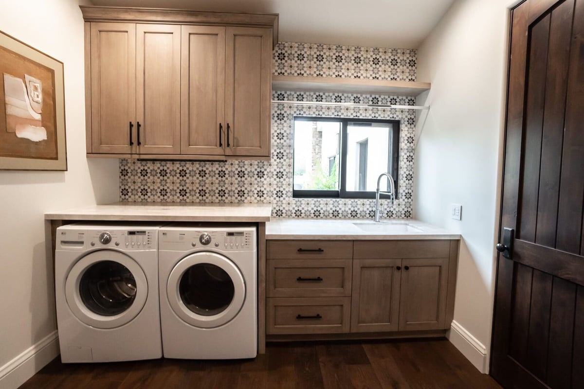 Updated laundry room featuring wooden cabinets, washer, and dryer, MGD Builders, Phoenix AZ 