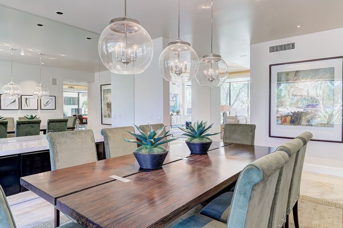 Elegant dining room with pendant lights and contemporary furniture, part of MGD Builders home renovation in Paradise Valley, Phoenix, AZ 