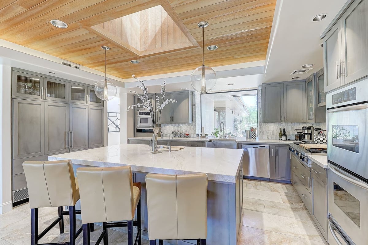 Elegant kitchen with open layout and marble countertops, showcasing custom home renovation by MGD Builders in Paradise Valley, Phoenix, AZ 