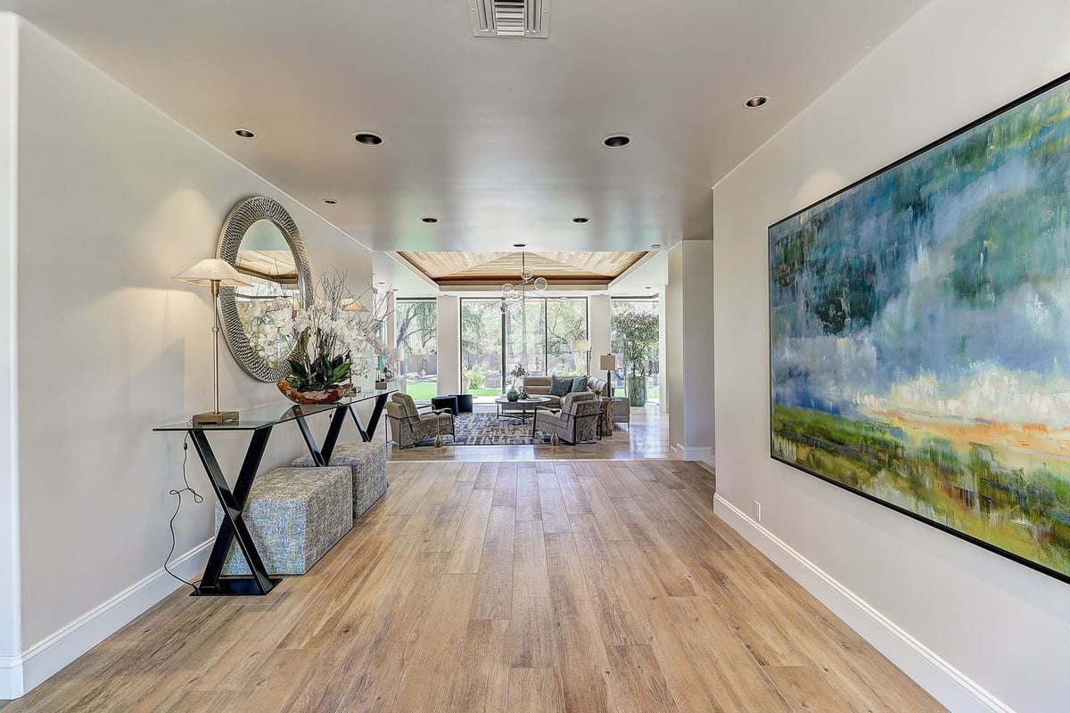 Entryway with contemporary art and hardwood floors in a custom home renovation by MGD Builders, Paradise Valley, Phoenix, AZ 