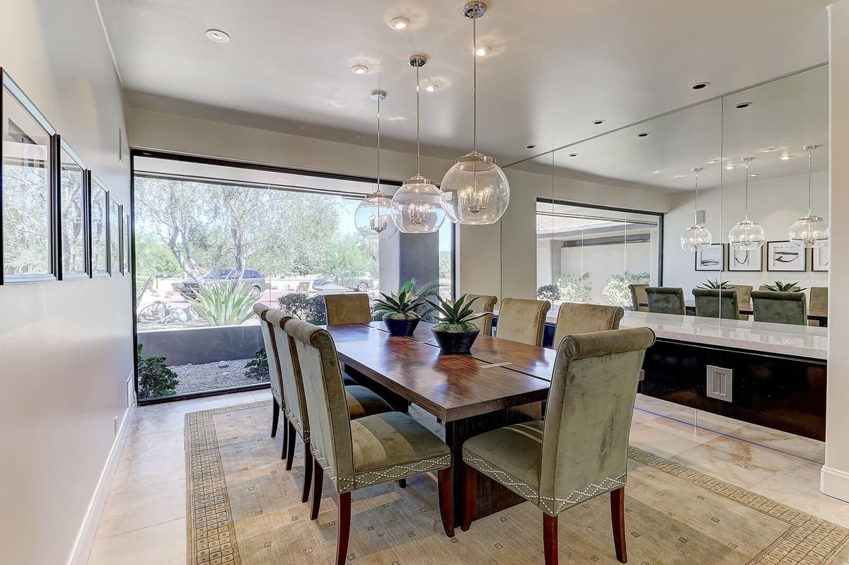 Modern dining room featuring a wood table and pendant lights, part of MGD Builders renovation project in Paradise Valley, Phoenix, AZ 