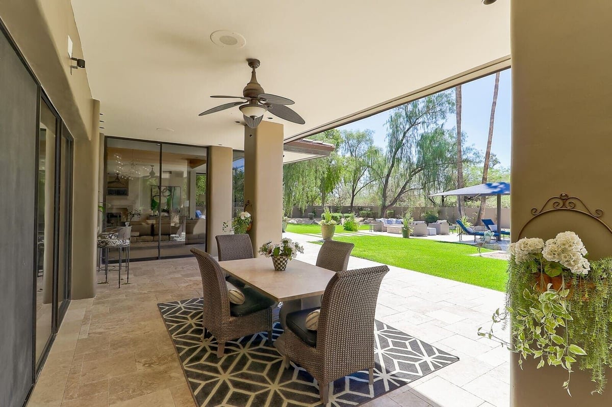 Outdoor patio with modern furniture and green lawn, part of MGD Builders whole home renovation in Paradise Valley, Phoenix, AZ 