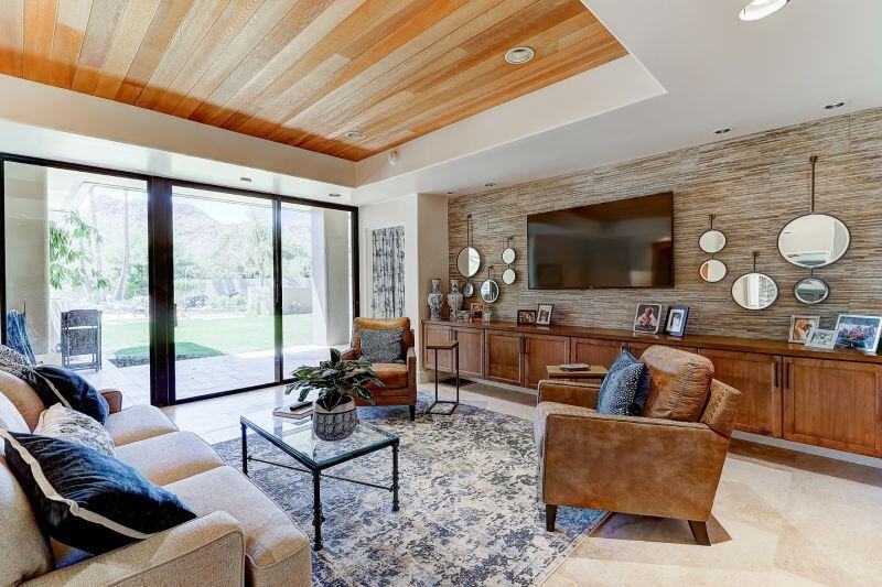 living room with wood ceiling and couches big floor to ceiling windows in phoenix az