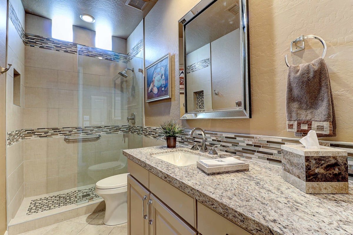 Elegant small bathroom remodel with a glass-enclosed shower and granite vanity, MGD Builders, Phoenix, AZ