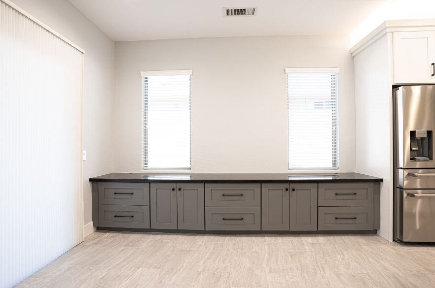 kitchen remodel with gray cabinet space under windows