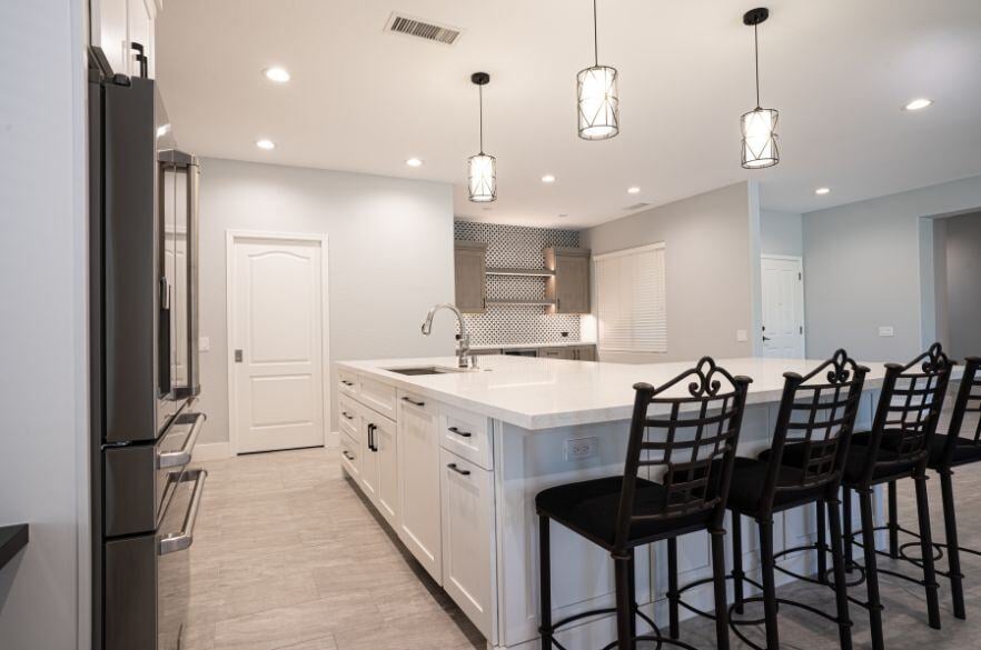 White Kitchen Remodel with Bar Stools and Kitchen Island in Surprise, Arizona